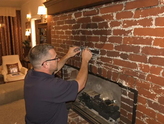 Sharon Chimney Sweep expert fixing a fireplace in Sharon, MA